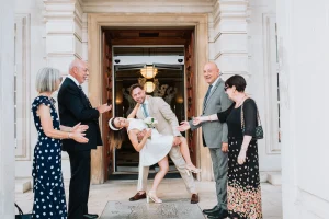 Walking out as one. Walthamstow wedding photographer capturing an emotional couple's exit from the Fellowship Civic Chamber, Waltham Forest Town Hall Walthamstow
