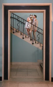 Fashion-inspired portrait of the newlyweds on the staircase at the Walthamstow Town Hall