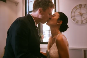 Newlyweds sharing their first kiss during their Camden Town Hall wedding.