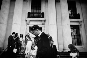 Newlyweds sharing their first kiss at Old Marylebone Town Hall. Iconic moment captured by London editorial photographer Gregory Kowalski.