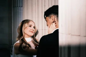 Fashion-inspired wedding editorial scene combining natural emotion at the exterior of the old marylebone town hall.